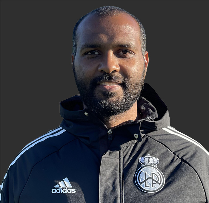 Thumbnail image of Mohaned Alagbash wearing a club Adidas jacket with club logo